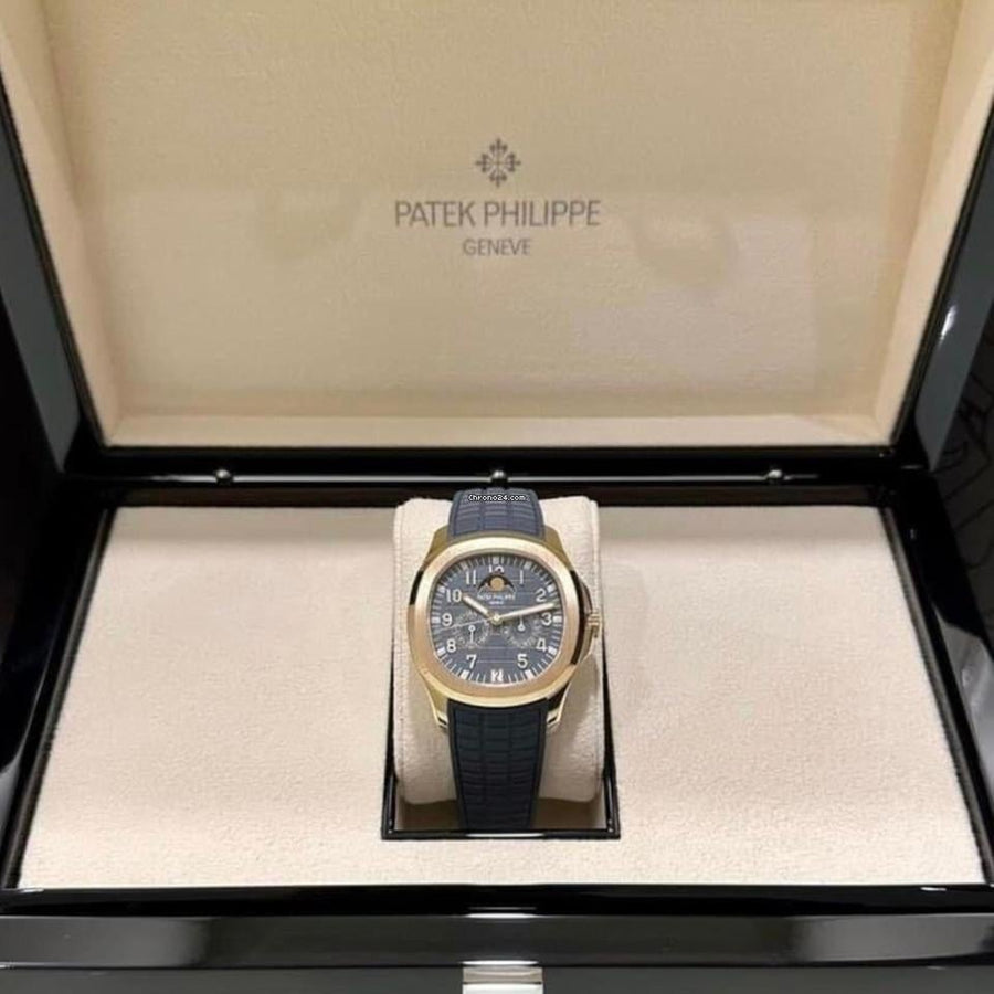 Patek Philippe Aquanaut Annual Calendar 5261R-001 in rose gold with blue-gray dial and blue composite strap, wide front view in the open presentation box