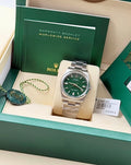 Rolex Oyster Perpetual 36 reference 126000 with green dial on Oystersteel Oyster bracelet, front view with booklets and hang tag
