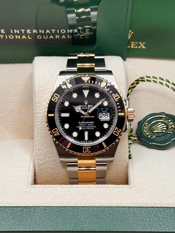 Rolex Submariner Date reference 126613LN black dial and black Cerachrom bezel on Yellow Rolesor Oyster bracelet, front view with box and hang tags