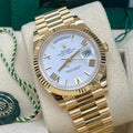 Rolex Day-Date 40 228238 front close-up with white Roman dial, fluted bezel and yellow-gold President bracelet