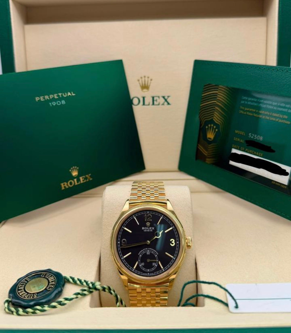 Rolex reference 52508 intense black dial in yellow gold on Settimo bracelet, front view with booklets and warranty card