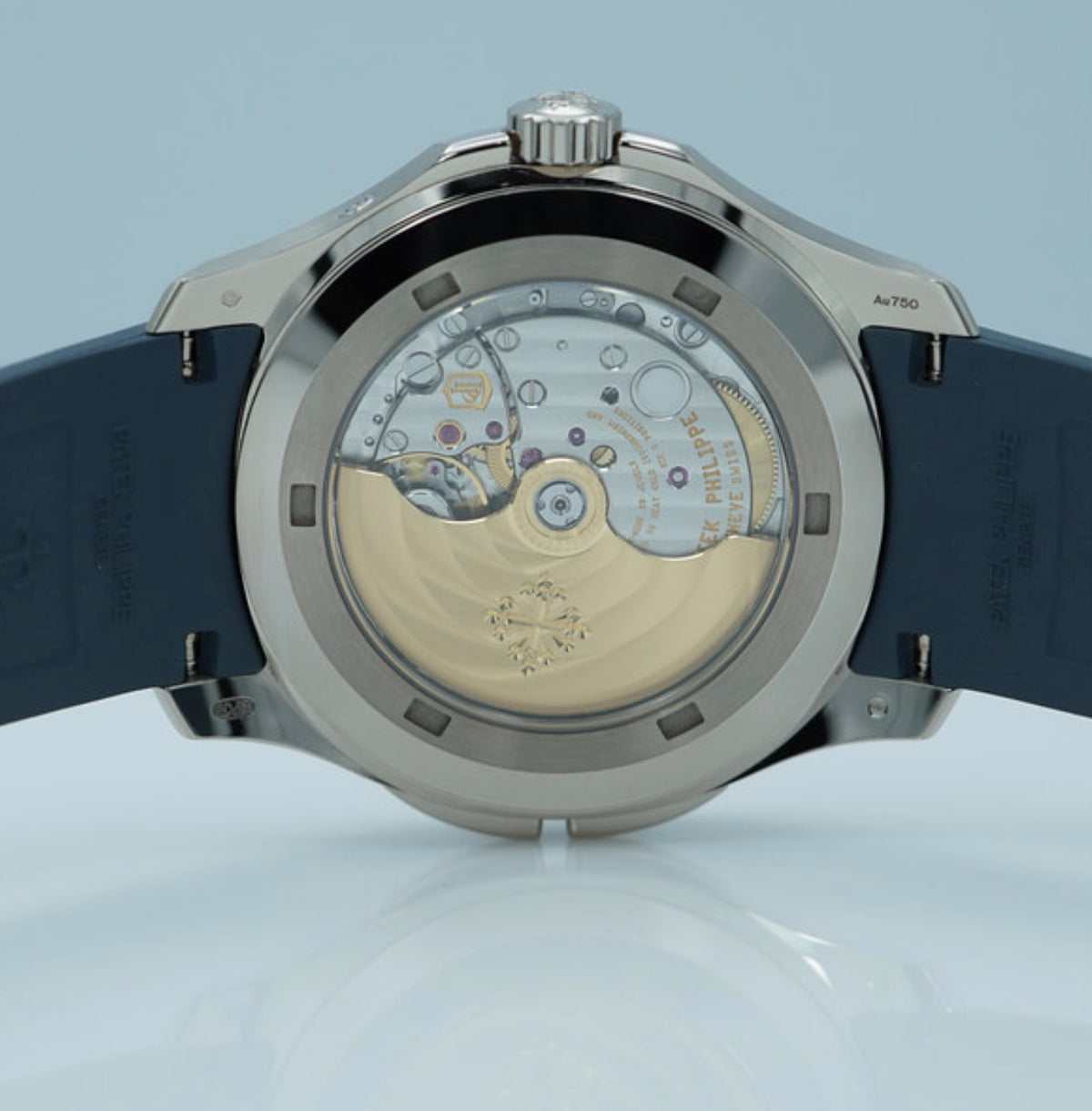 Patek Philippe Aquanaut Travel Time 5164G-001 in white gold with blue dial and blue composite strap, sapphire caseback view of the self-winding movement