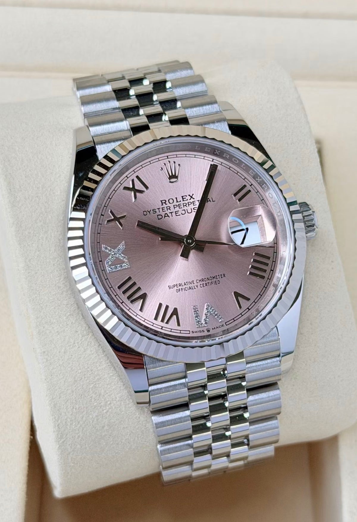 Rolex Datejust 36 126234 White Rolesor, pink Roman dial, diamond accents on Jubilee bracelet, raised front view on a display cushion