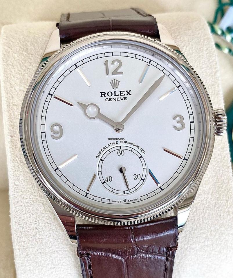 Rolex Perpetual 1908 52509 front view with white dial, white-gold case and brown leather strap on cushion