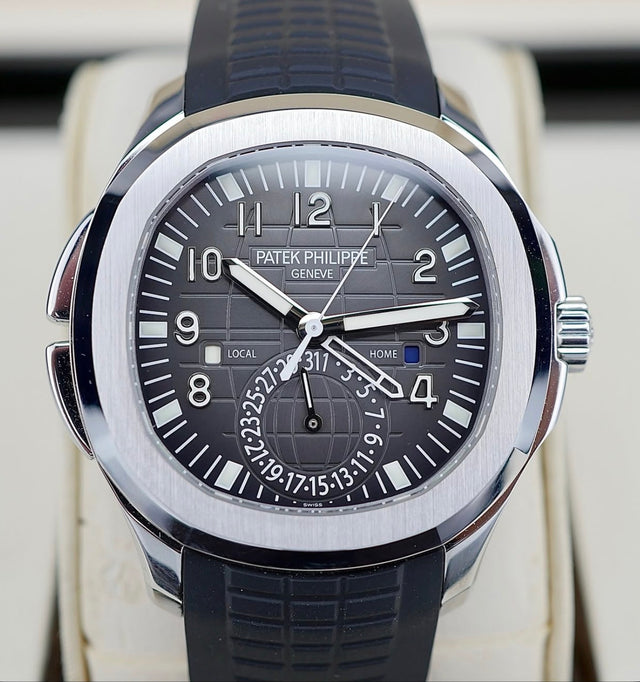Patek Philippe Aquanaut Travel Time 5164A-001 in steel with black embossed dial and black composite strap, tight straight-on dial view