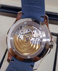 Patek Philippe Aquanaut Travel Time 5164G-001, exhibition caseback view showing the movement and blue strap