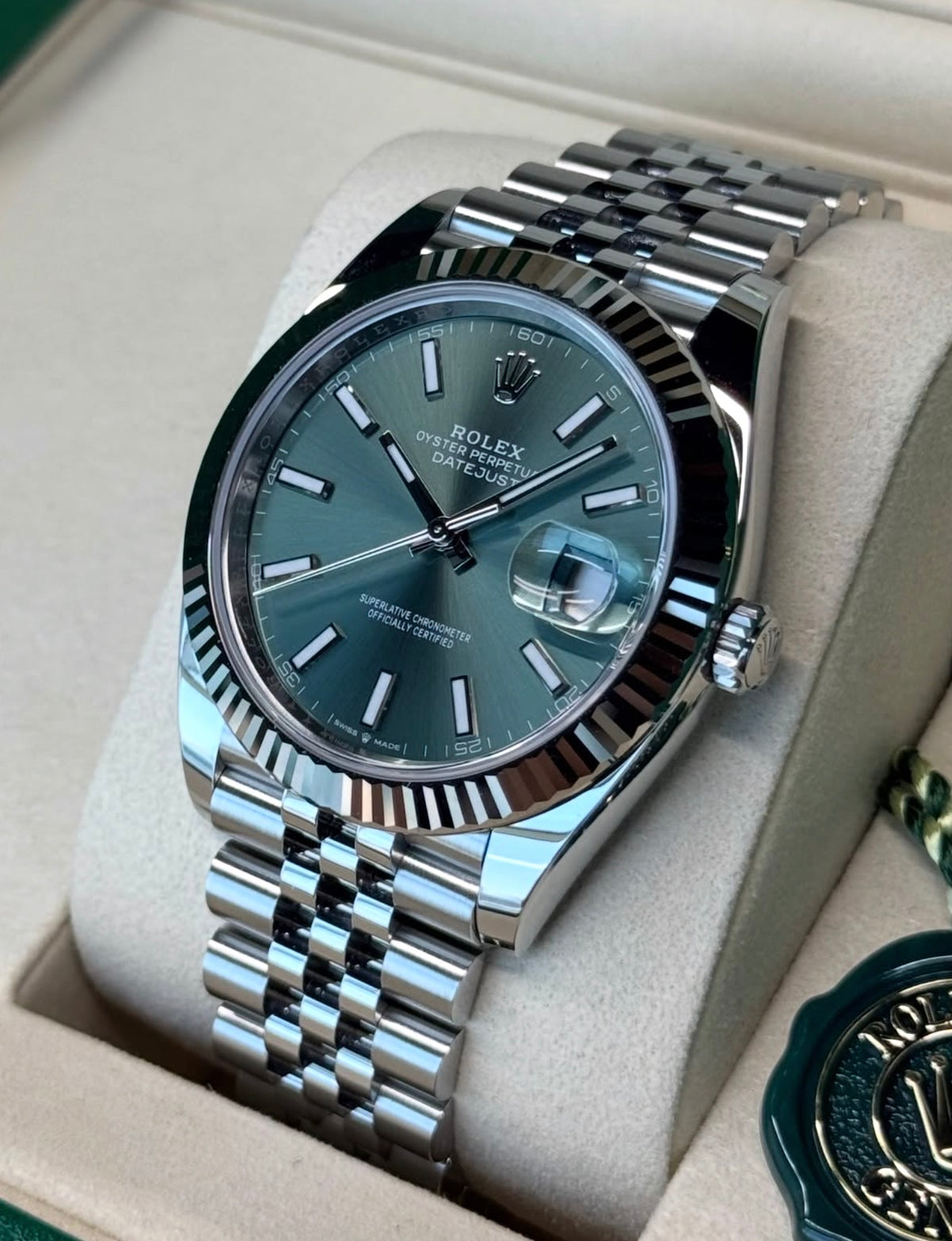 Rolex Datejust 41 126334 White Rolesor, mint-green dial on Jubilee bracelet, opposite-angle front view in an open Rolex box