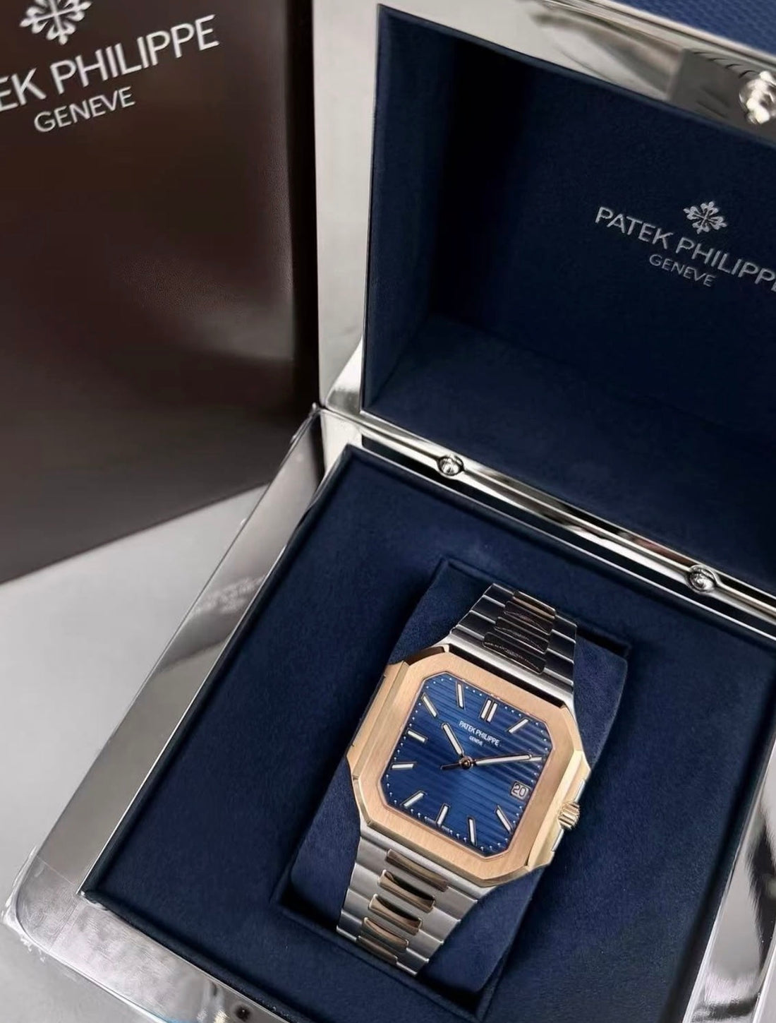 Patek Philippe Cubitus 5821/1AR-001 displayed in its presentation box with the blue dial and rose-gold-and-steel bracelet visible