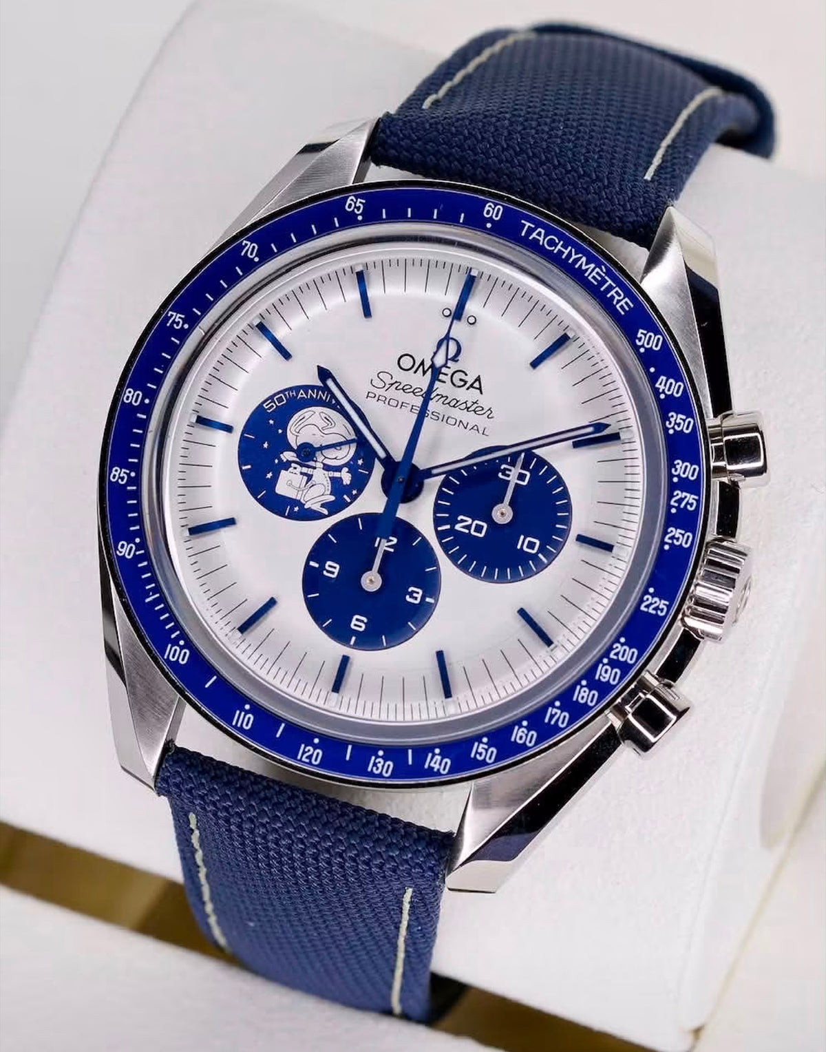 Omega Speedmaster Silver Snoopy Award 310.32.42.50.02.001 white dial and blue strap, three-quarter view