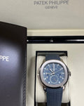 Patek Philippe Aquanaut 5164G-001 in presentation box beside leather document wallet