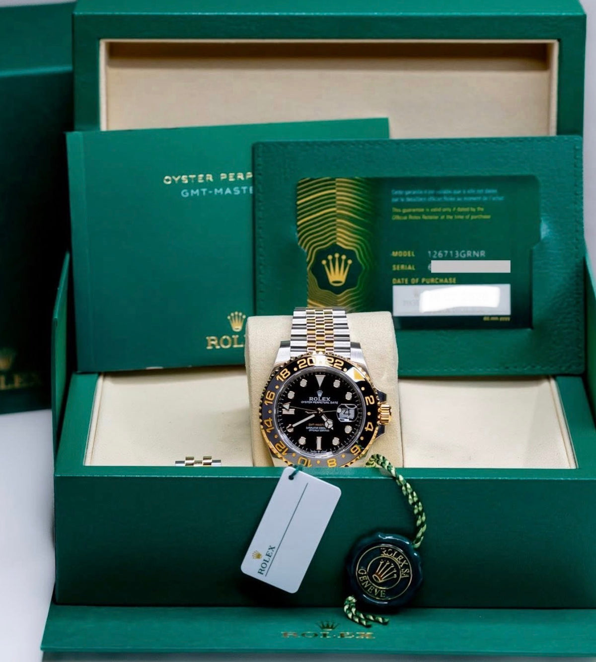 Rolex GMT-Master II ref. 126713GRNR in Yellow Rolesor with black-and-grey Cerachrom bezel and Jubilee bracelet, presentation-box view with card and accessories