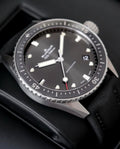 Blancpain watch 5000-1110-B52A — angled front view of dial and bezel with black fabric strap