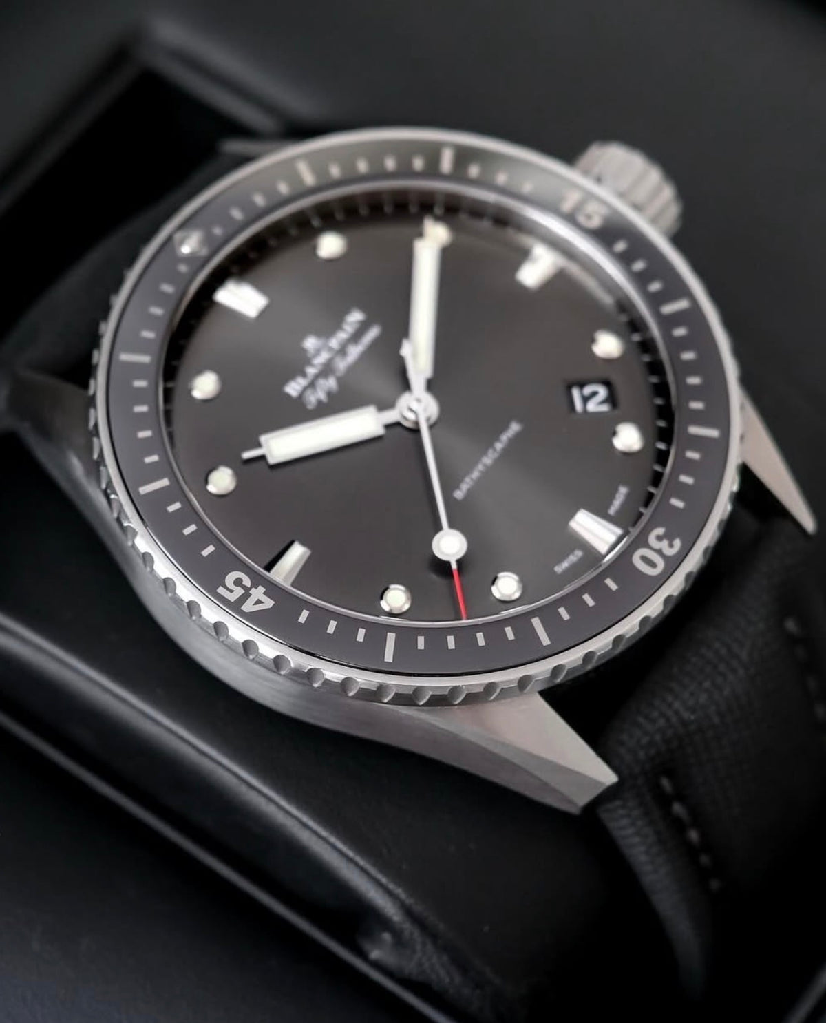 Blancpain watch 5000-1110-B52A — angled front view of dial and bezel with black fabric strap