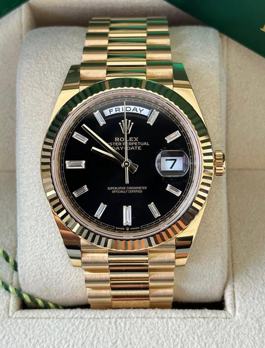 Rolex Day-Date 40 reference 228238 black baguette-diamond dial on yellow gold President bracelet, straight-on front view