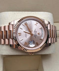 Rolex Day-Date 40 228235 horizontal dial view on cushion with Sundust Roman dial and Everose gold President bracelet