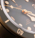 Tudor Black Bay Bronze M79250BA-0001, slate-gray dial and bezel with black nubuck strap, dial text and hands close-up