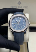 Patek Philippe Aquanaut 5164G-001 blue dial, front view held in a gloved hand