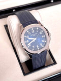 Patek Philippe Aquanaut 5168G-001 in white gold with blue embossed dial and blue composite strap, wide three-quarter front view in the box