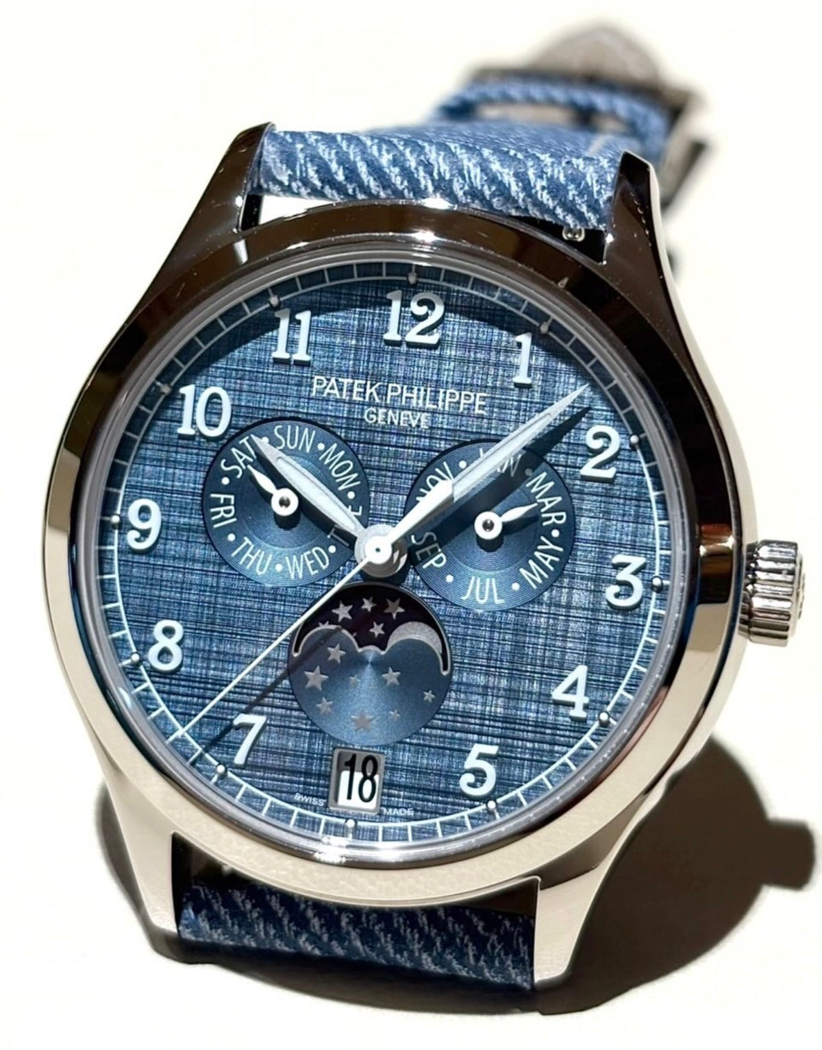 Patek Philippe Annual Calendar Moon Phases 4946G-001 with blue-gray dial, angled front view in natural light