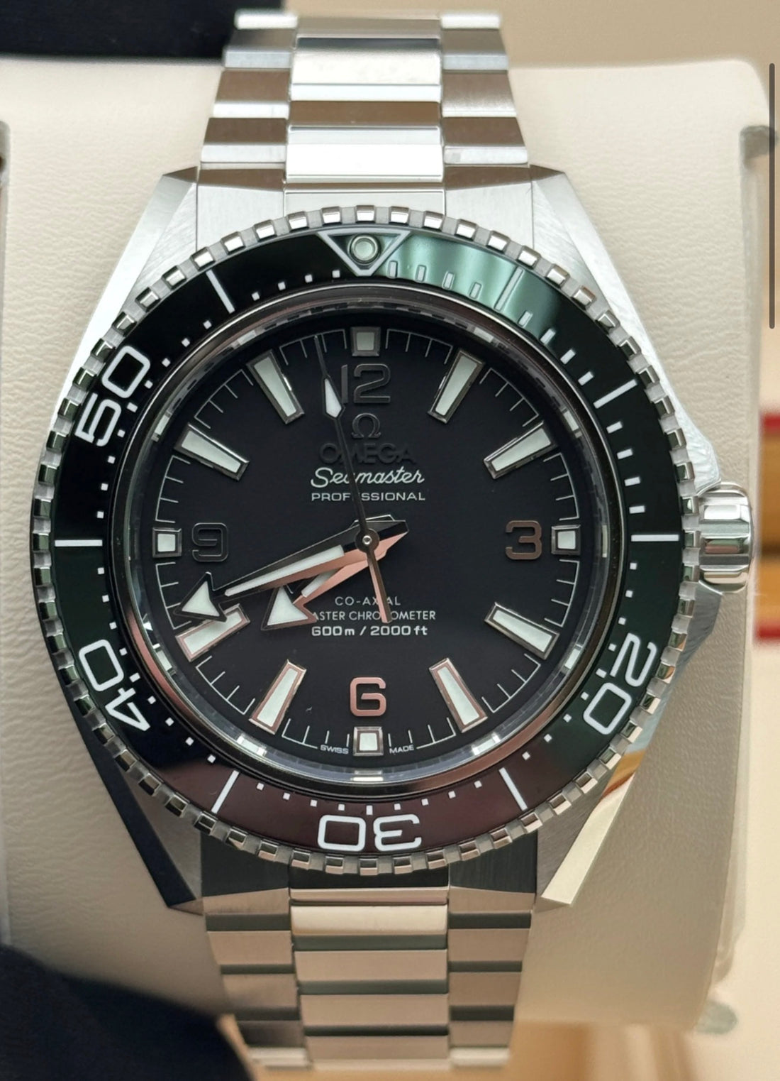 Omega Seamaster Planet Ocean 600M 217.30.42.21.01.001, black dial and bezel with steel bracelet, straight-on front view in the presentation box
