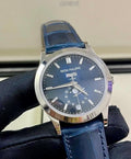 Patek Philippe Annual Calendar 5396G-017 in white gold with blue dial and blue alligator strap, three-quarter front view held in a gloved hand