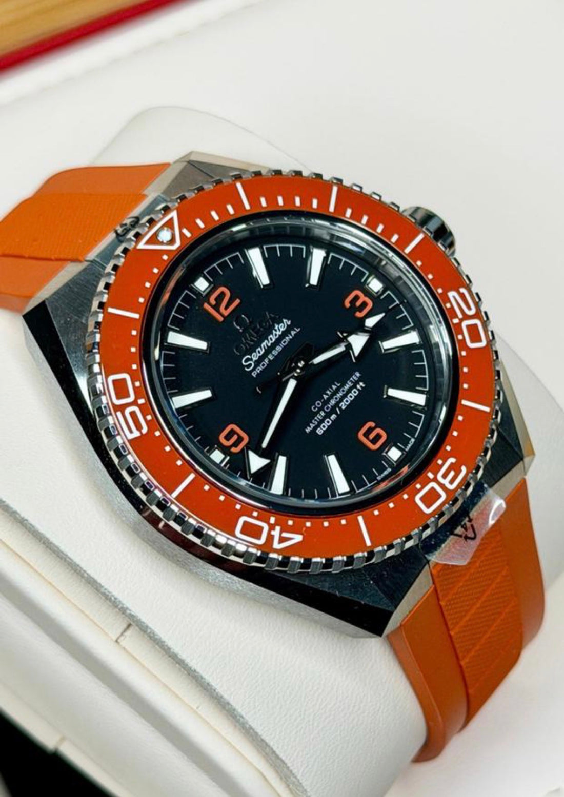 Omega Seamaster Planet Ocean 600M 217.32.42.21.01.004, black dial, orange bezel and rubber strap, left three-quarter front view