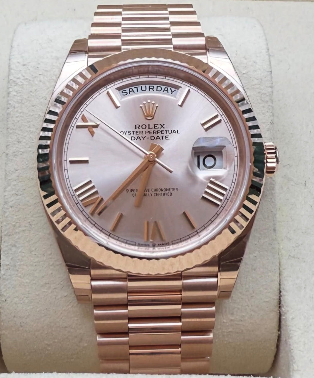 Rolex Day-Date 40 228235 straight-on close-up on cushion with Sundust Roman dial, fluted bezel and President bracelet