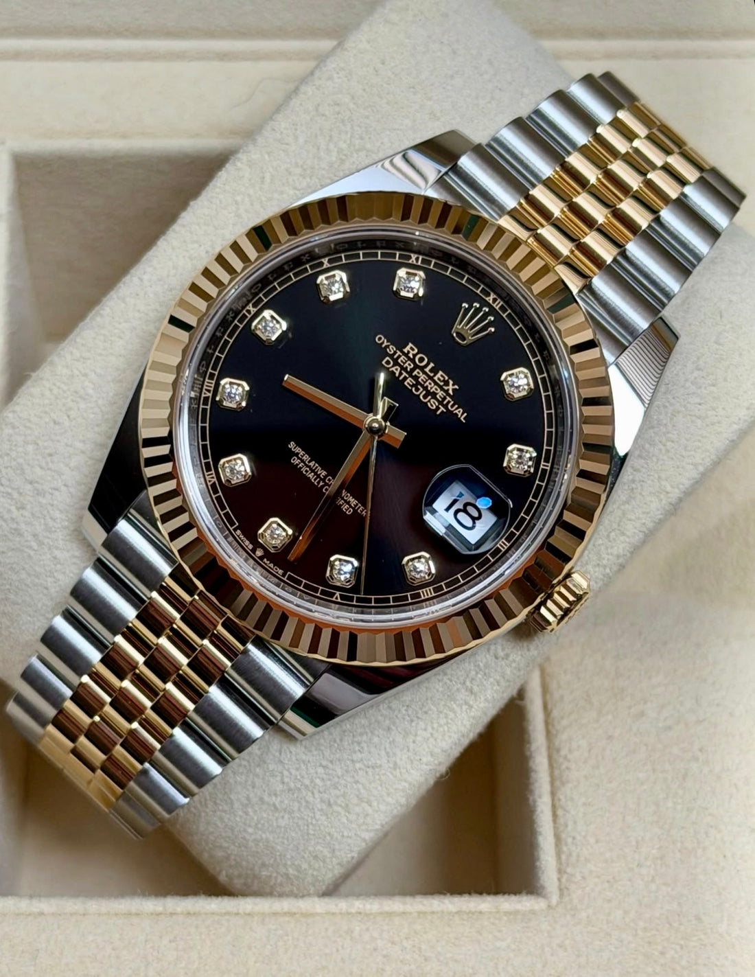 Rolex Datejust 41 126333 Yellow Rolesor, black diamond dial on Jubilee bracelet, angled front view on a display cushion