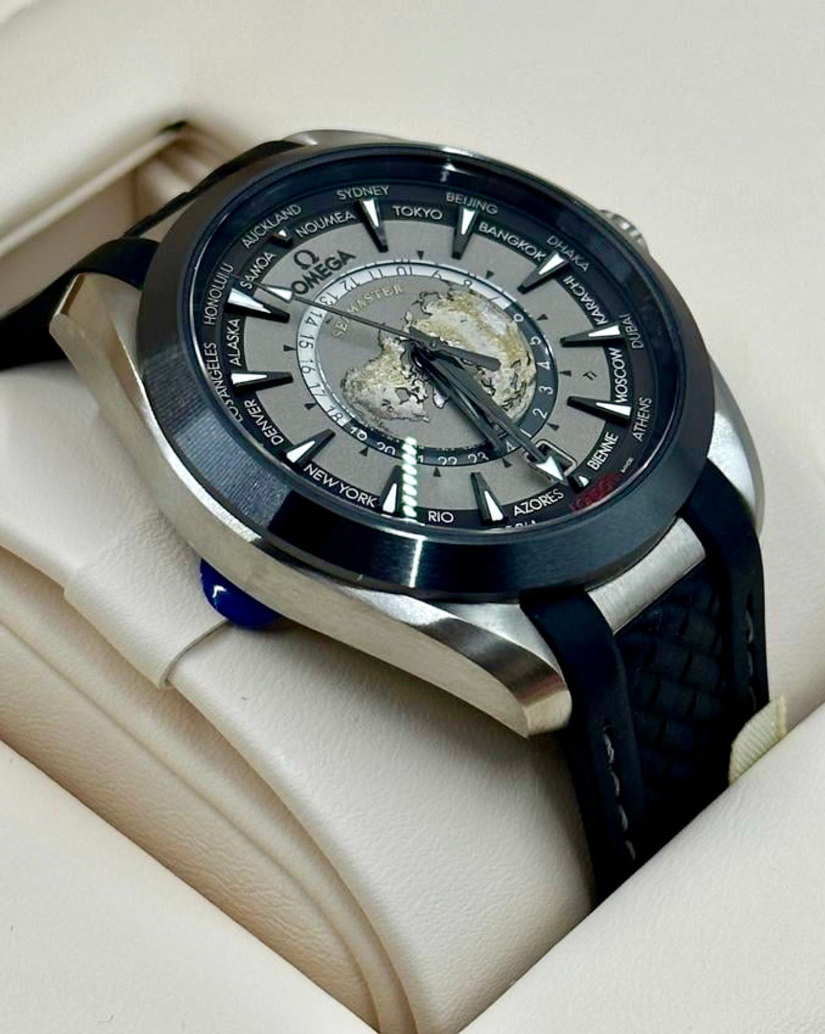 Left-side profile of the Omega Aqua Terra Worldtimer titanium case, lugs and black rubber strap