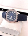Patek Philippe Aquanaut 5168G-001 in white gold with blue embossed dial and blue composite strap, horizontal front view on a cushion