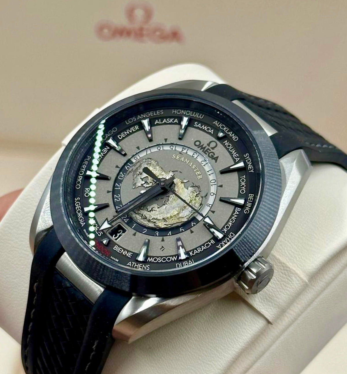 Three-quarter view of the Omega Aqua Terra Worldtimer showing its dial, crown and rubber strap
