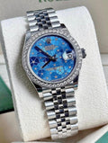 Rolex Datejust 31 278384RBR White Rolesor, blue floral diamond dial, diamond bezel on Jubilee bracelet, angled front view on a display cushion