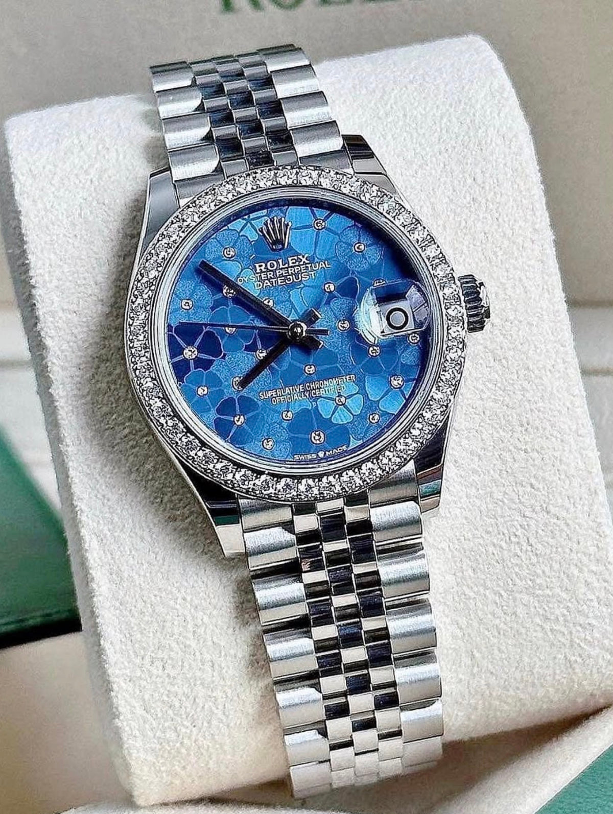 Rolex Datejust 31 278384RBR White Rolesor, blue floral diamond dial, diamond bezel on Jubilee bracelet, angled front view on a display cushion