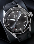 Blancpain watch 5000-1110-B52A — dark dial, rotating bezel and fabric strap, angled front view