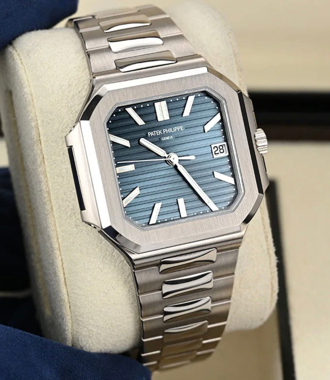 Patek Philippe Cubitus 7128/1G-001 in white gold, front view of the blue-gray embossed dial and integrated bracelet on a cushion