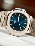 Patek Philippe Nautilus 5811/1G-001 in white gold with blue embossed dial and integrated bracelet, three-quarter front studio view