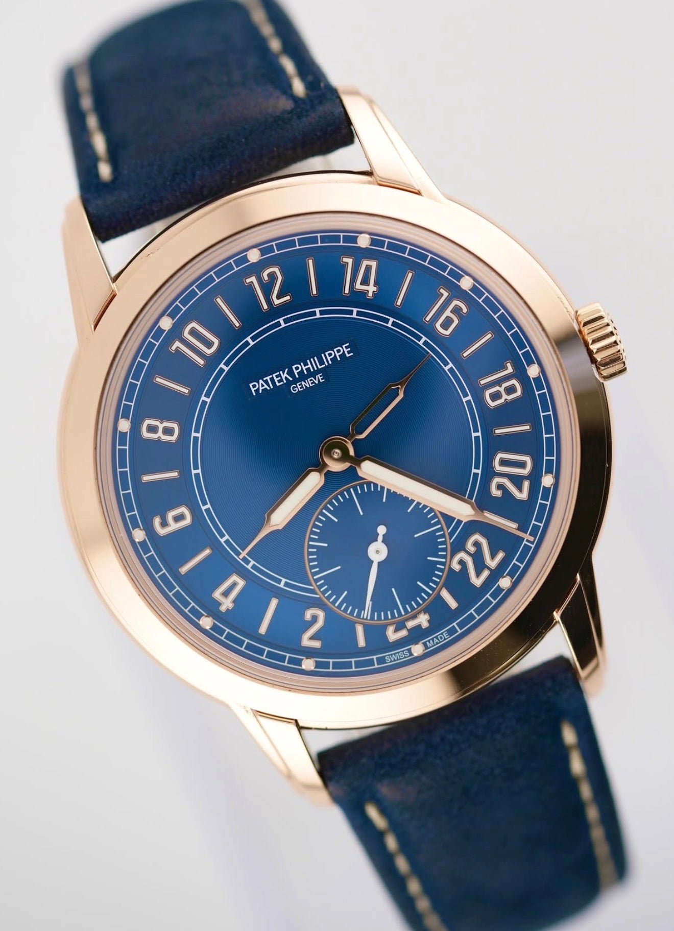 Patek Philippe 24-Hour Travel Time 5224R-001 in rose gold with blue dial and blue calfskin strap, three-quarter front product view