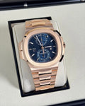 Patek Philippe Nautilus Travel Time Chronograph 5990/1R-001 in rose gold with blue dial and bracelet, wide front view in the presentation box