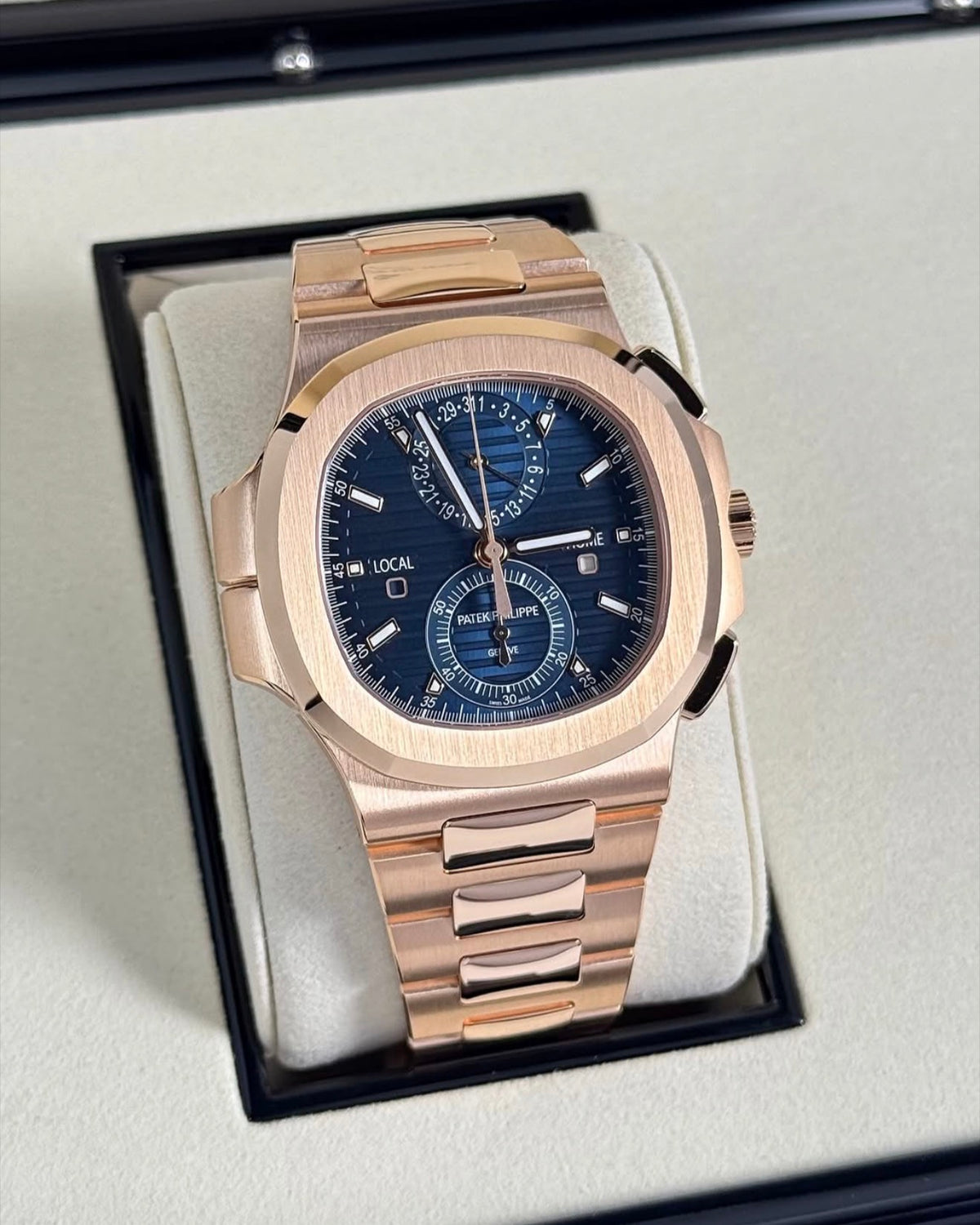 Patek Philippe Nautilus Travel Time Chronograph 5990/1R-001 in rose gold with blue dial and bracelet, wide front view in the presentation box