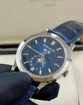 Patek Philippe Annual Calendar 5396G-017 in white gold with blue dial and blue alligator strap, angled front view held in a gloved hand