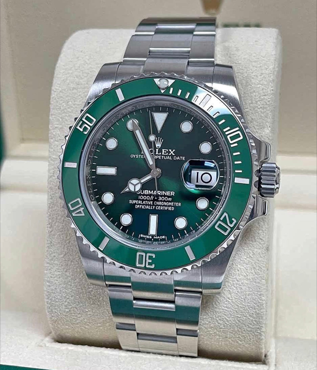 Rolex Submariner Date Hulk 116610LV with green sunburst dial, green ceramic bezel and stainless steel Oyster bracelet, front view on a cushion
