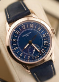 Patek Philippe 24-Hour Travel Time 5224R-001 in rose gold with blue dial and blue calfskin strap, angled front close-up