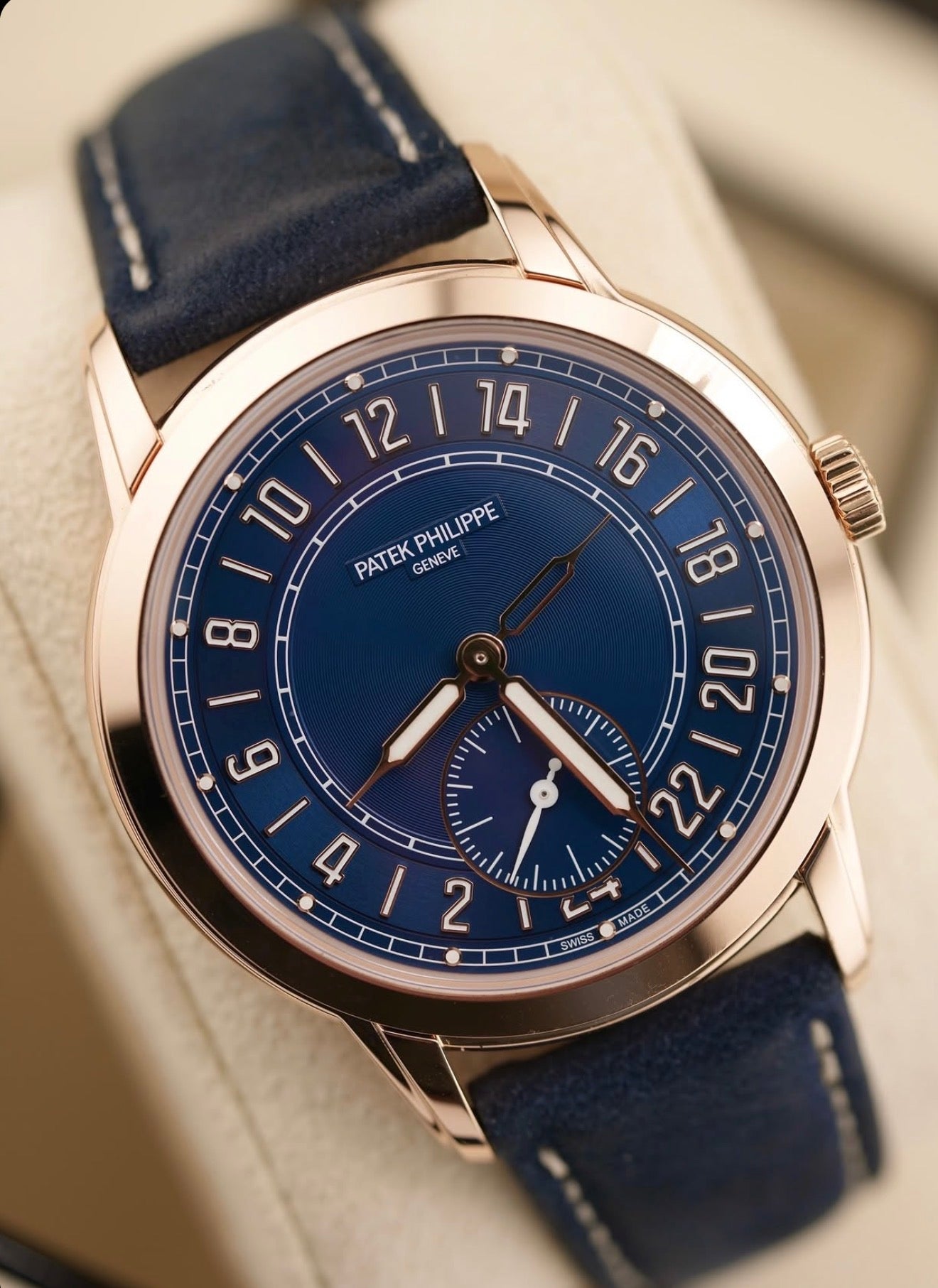 Patek Philippe 24-Hour Travel Time 5224R-001 in rose gold with blue dial and blue calfskin strap, angled front close-up