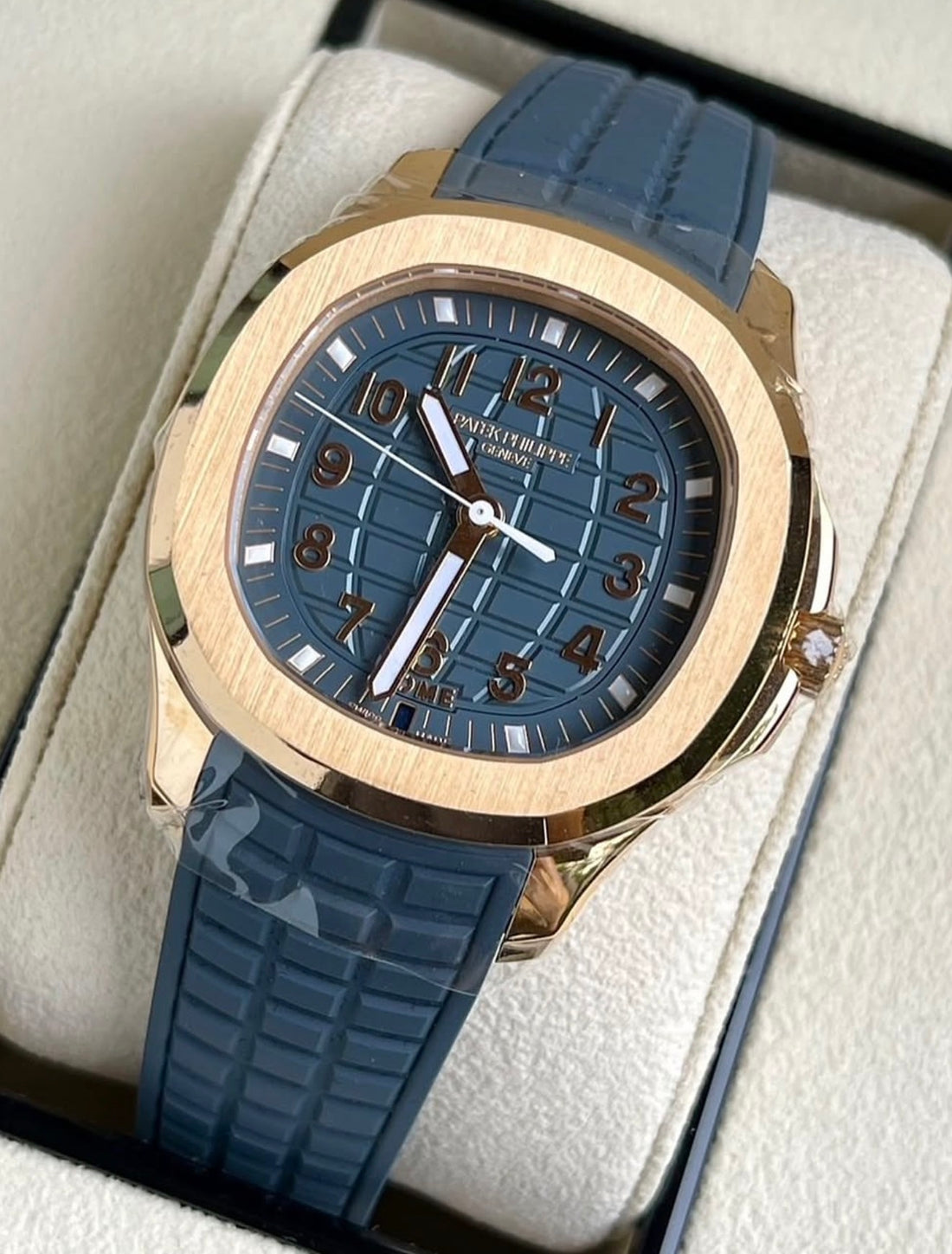 Patek Philippe Aquanaut 5269R-001 in rose gold with blue dial and blue composite strap, three-quarter front view on a cushion