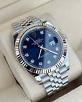 Rolex Datejust 41 126334 left three-quarter close-up on cushion with blue diamond-set dial, fluted bezel and Jubilee bracelet