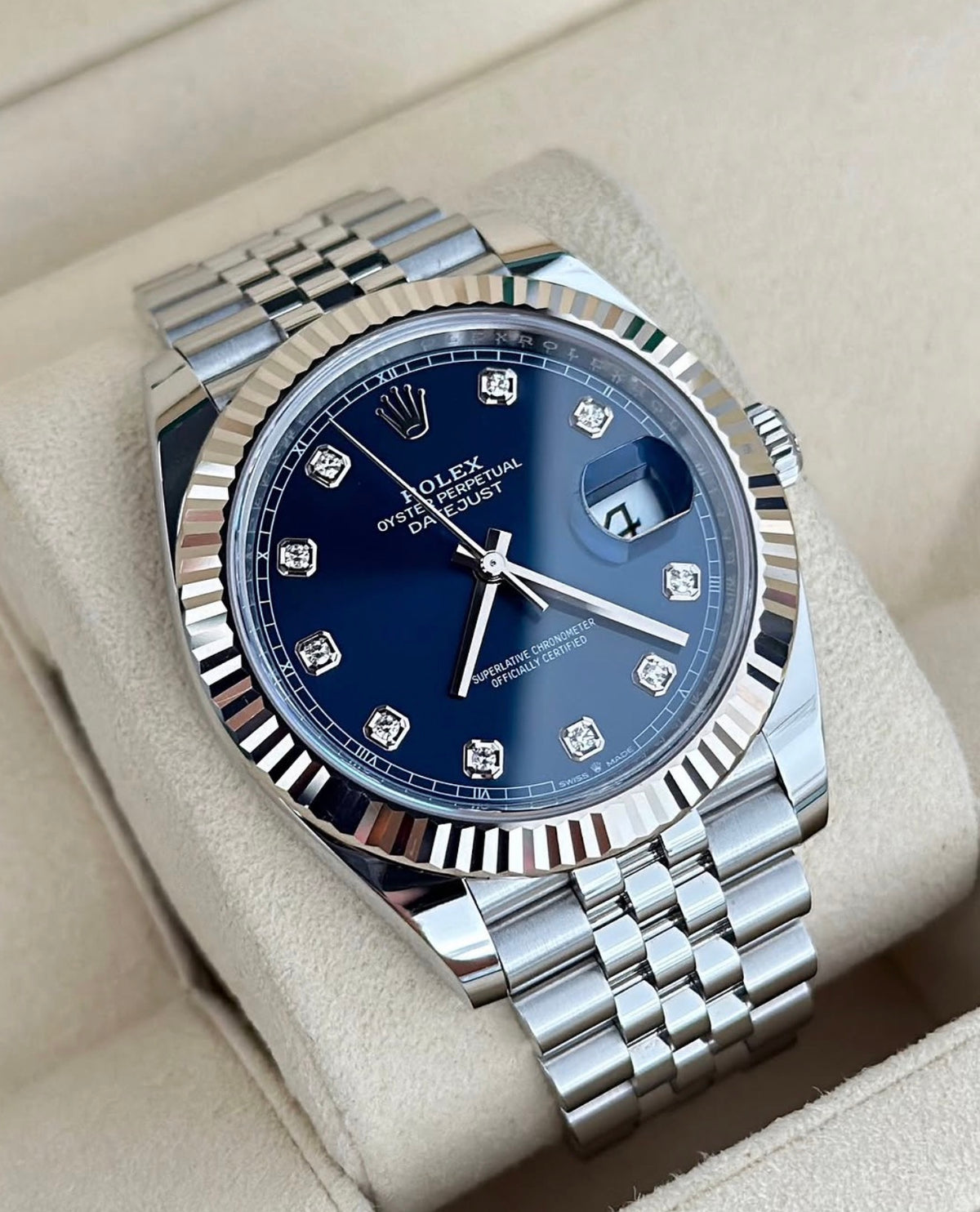 Rolex Datejust 41 126334 left three-quarter close-up on cushion with blue diamond-set dial, fluted bezel and Jubilee bracelet