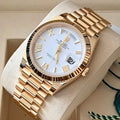 Rolex Day-Date 40 228238 three-quarter view with white Roman dial and yellow-gold President bracelet