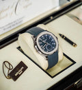 Patek Philippe Aquanaut Travel Time 5164G-001 in white gold with blue dial and blue composite strap, angled front view in the presentation box