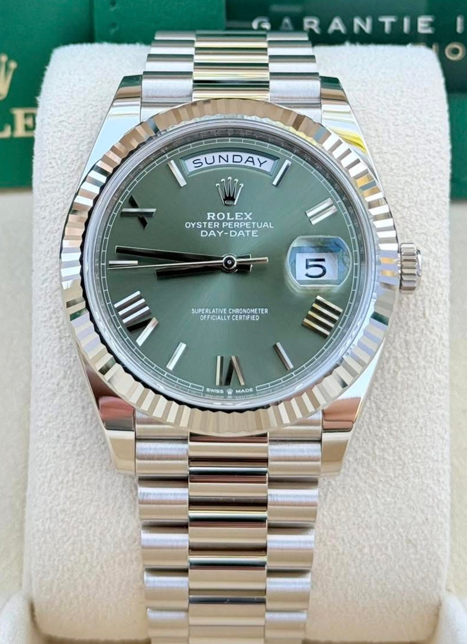 Rolex Day-Date 40 reference 228236 in platinum with olive-green Roman dial, fluted bezel and President bracelet, front view