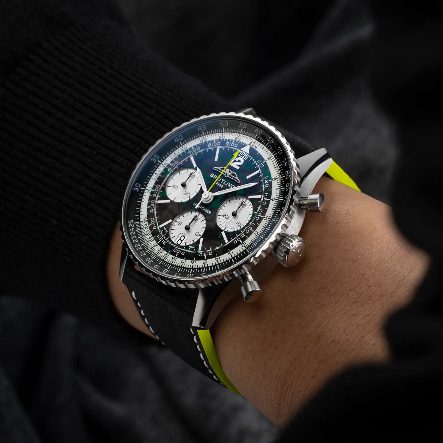 Breitling Navitimer B01 Chronograph 43 Aston Martin Aramco Formula ONE™ team reference EB01381A1B1X1 with Carbon dial, Titanium case, leather strap, on-wrist view